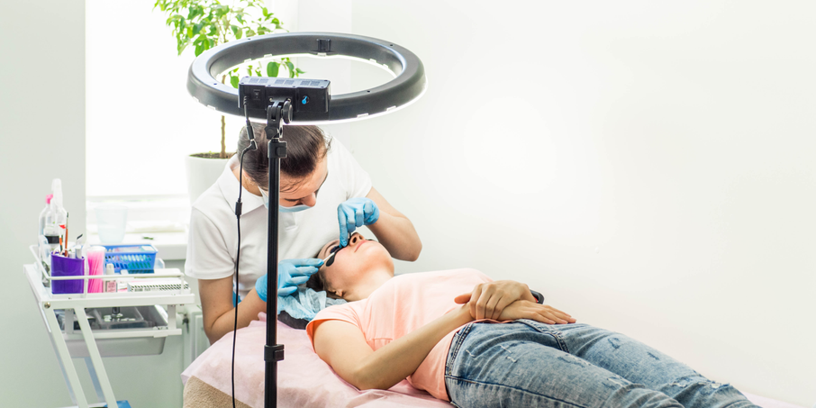 Client have an eyelash extension application in salon