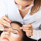 Women doing eyelash extensions