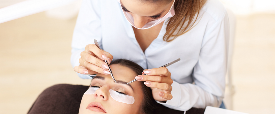 Women doing eyelash extensions