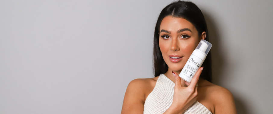Girl holding a prolong lash foaming pump by her face